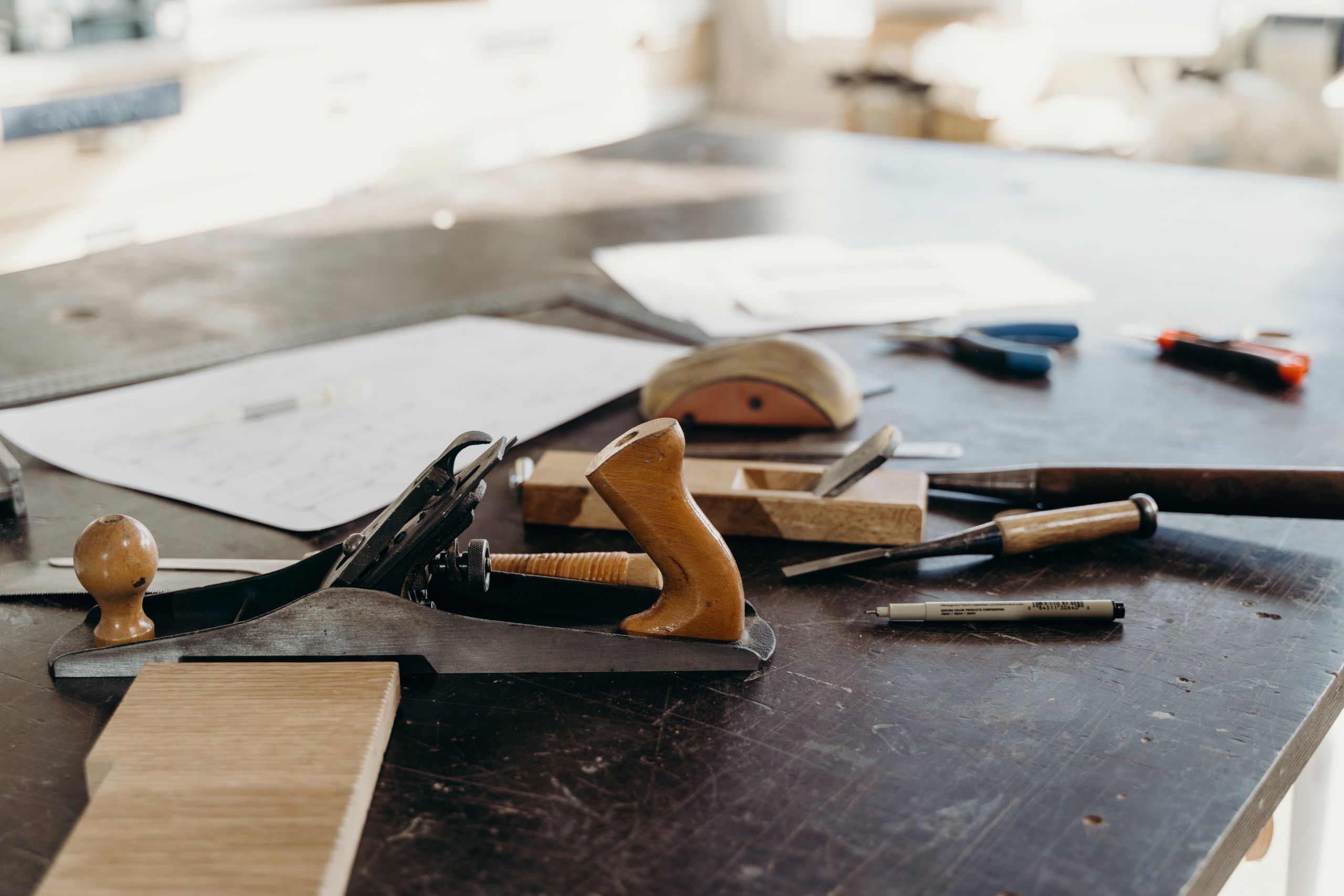 A selection of woodworking tools on a workshop table, highlighting craftsmanship.